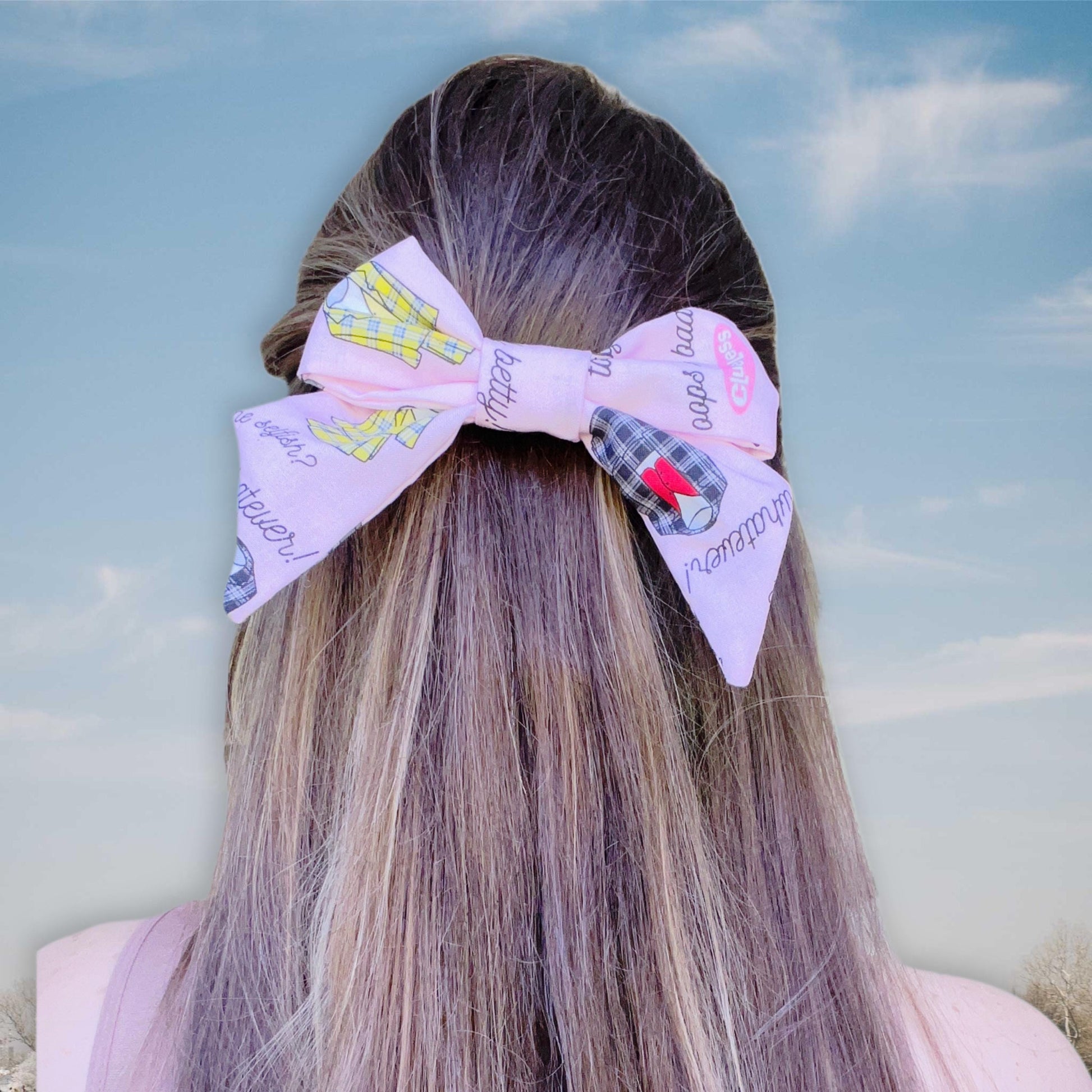 Trendy & Modern
This pink cotton hair clip (5in x 5in) is all about bold style! Decked out in pop art-inspired notes and suit designs in yellow or gray, it’s a must-have accessory for turning heads—whether it’s brunch or a night out.