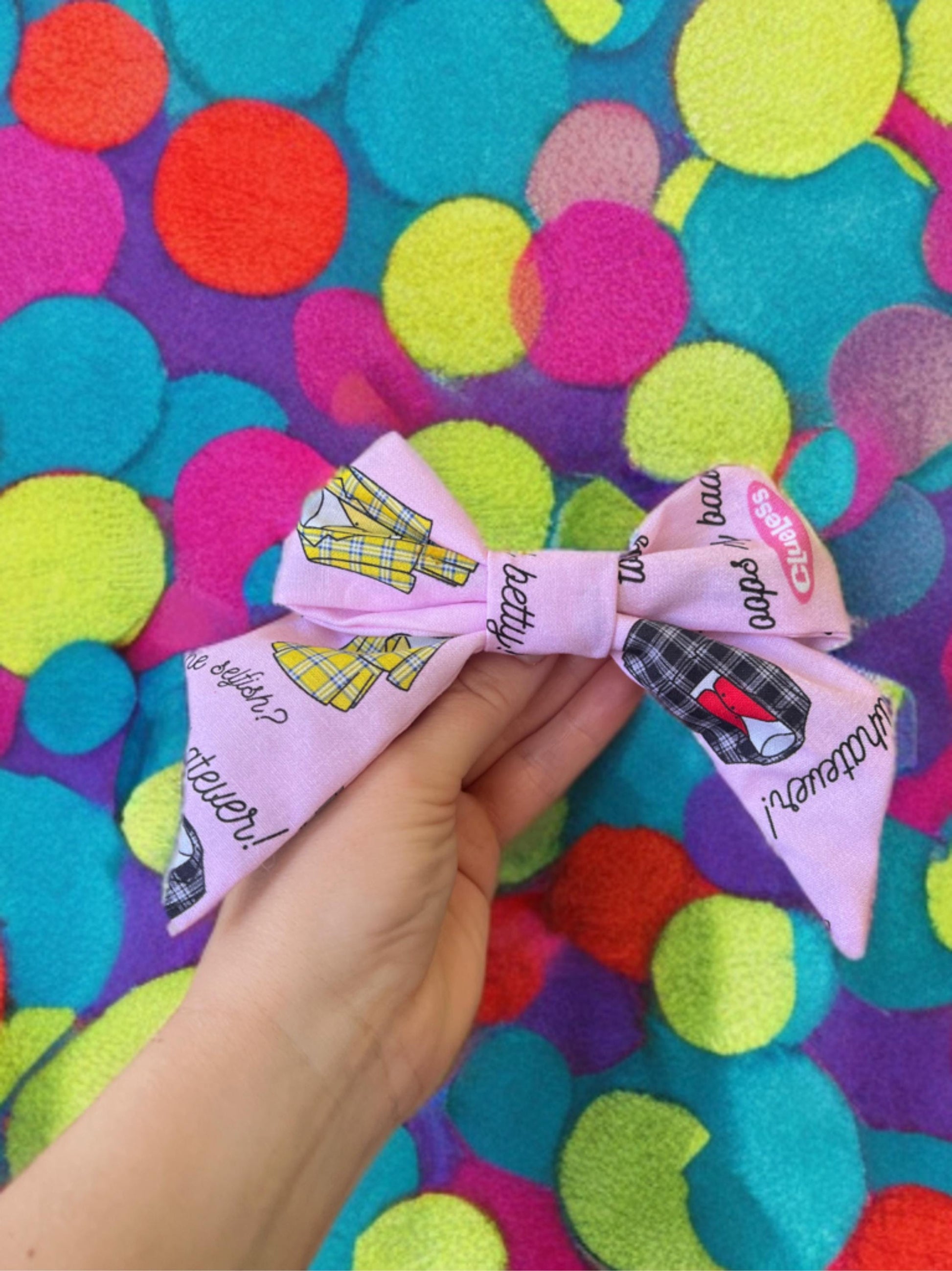 Pink 5 in x 5 in cotton hair clip with pop art notes and yellow or gray suits on in, perfect size for any occasion.