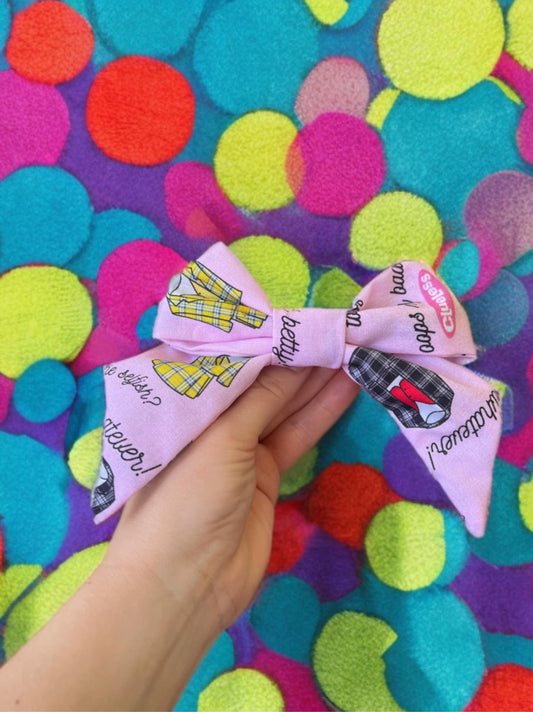 Pink 5 in x 5 in cotton hair clip with pop art notes and yellow or gray suits on in, perfect size for any occasion.